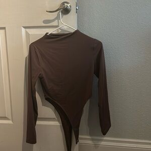 Brown body suit.